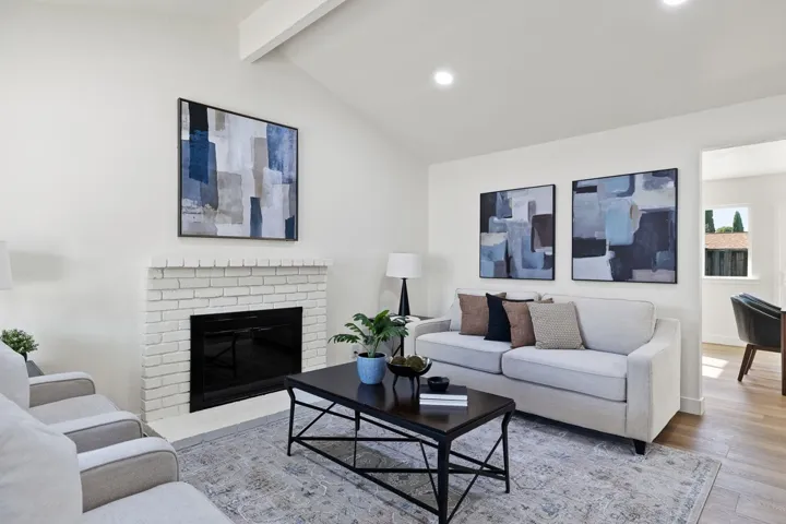 Living room featuring a fireplace, wood finished floors, and recessed lighting