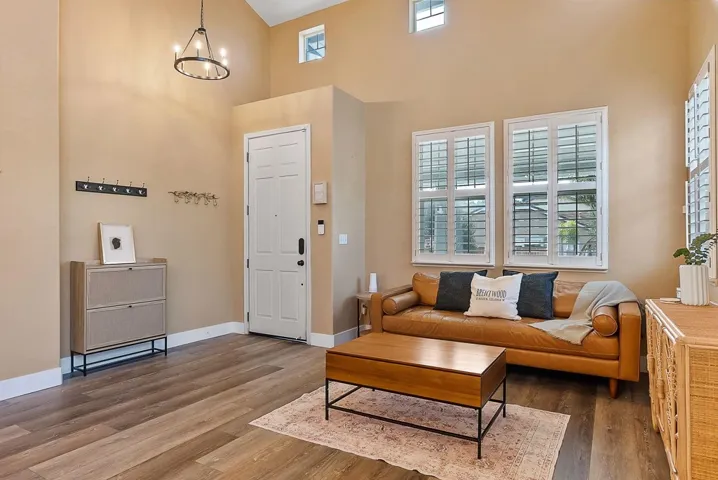 Living area featuring wood finished floors and a chandelier