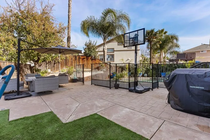 Fenced backyard featuring outdoor lounge area, area for grilling, and a patio