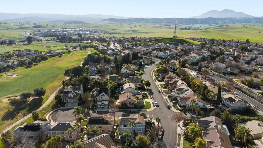 Aerial view of residential area featuring a mountainous background