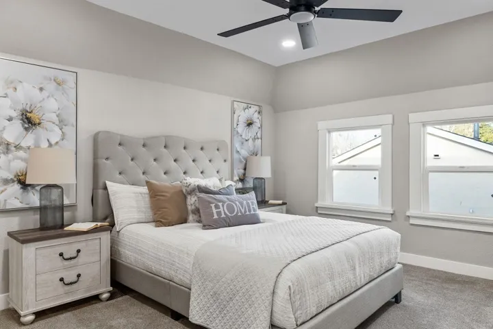 Carpeted bedroom with ceiling fan and recessed lighting