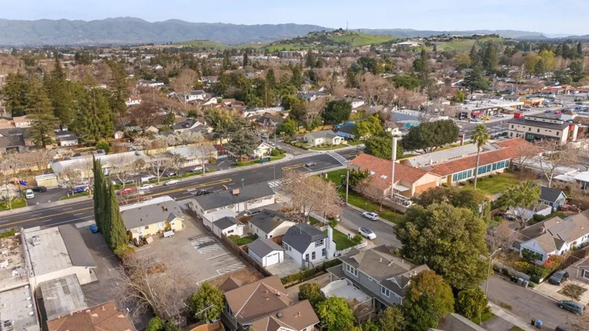 Aerial view of property's location with a mountainous background and nearby suburban area