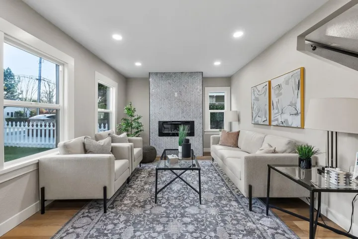 Living room with recessed lighting, a fireplace, and wood finished floors