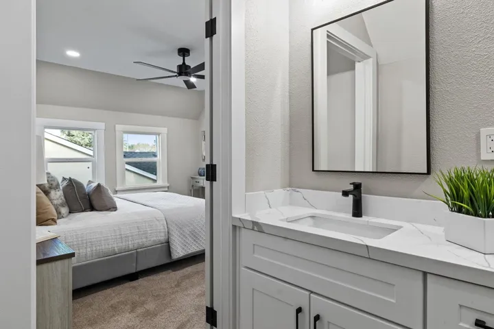 Carpeted bedroom featuring lofted ceiling, ceiling fan, a textured wall, and recessed lighting