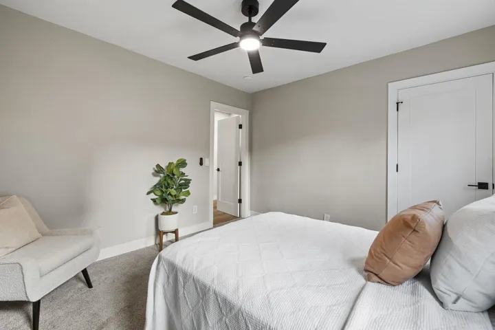 Bedroom with carpet floors, a ceiling fan, and a closet