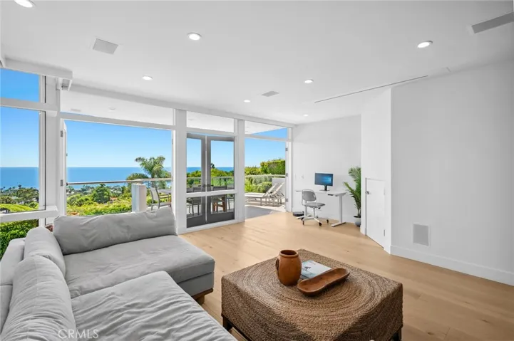  On the lower levels, three additional bedrooms accompany a secondary living area perfectly suited as a home theater with a retractable cinema screen and high-resolution projector.