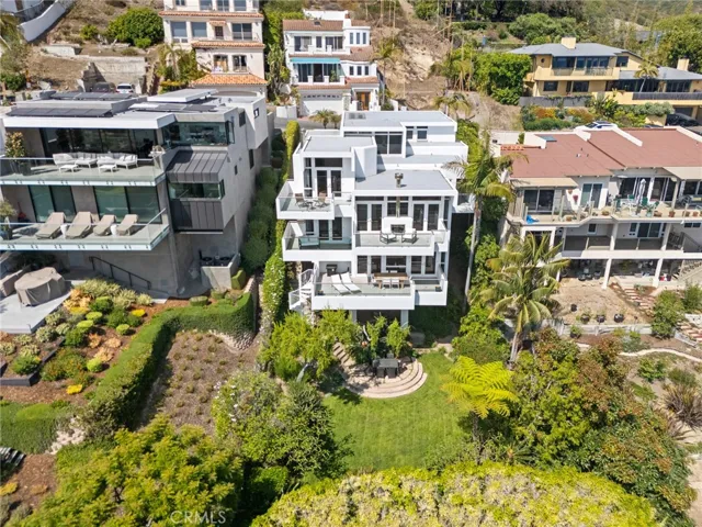These spaces open directly to a large entertaining deck and an oversized, landscaped backyard offering privacy, versatility, and a beautiful setting for gatherings or quiet evenings under the stars.