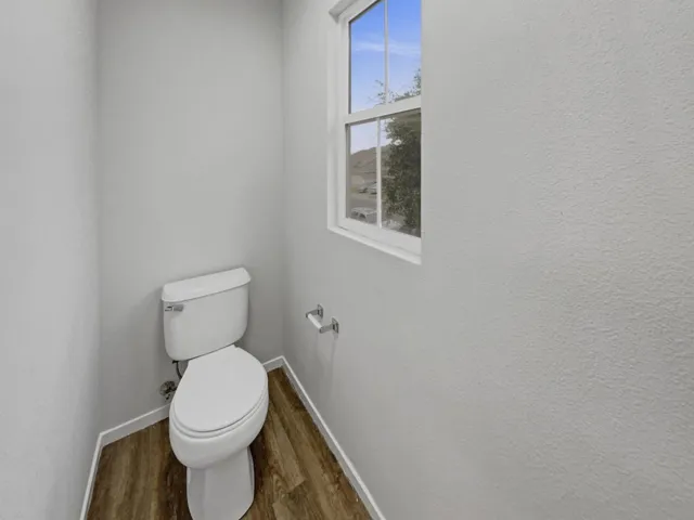 Bathroom featuring dark wood finished floors and baseboards
