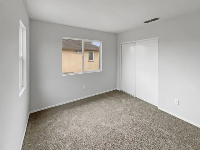 Unfurnished bedroom with carpet flooring and a closet