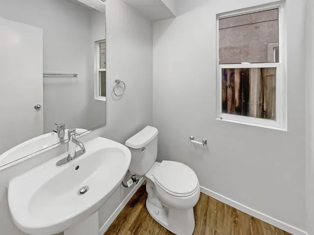 Bathroom featuring a sink and wood finished floors