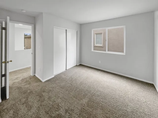 Unfurnished bedroom with carpet floors and a closet