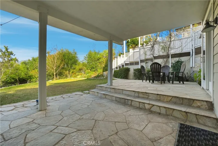 LOWER LEVEL STONE DECK AREA TO YARD