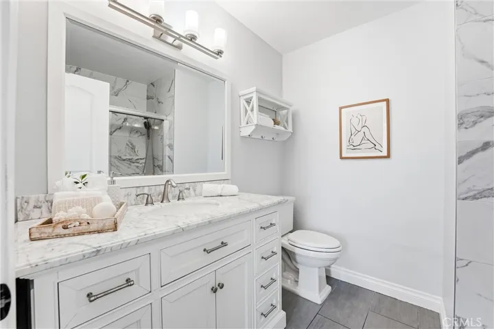 1st floor remodeled guest bathroom with tub and shower.