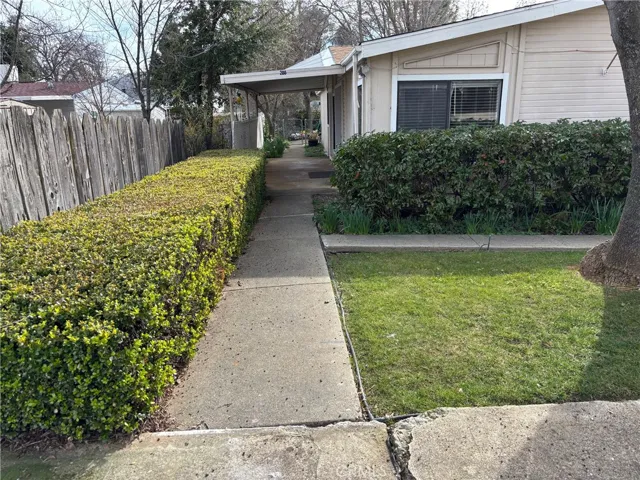 Front walkway to entrance and beautiful fenced back yard.