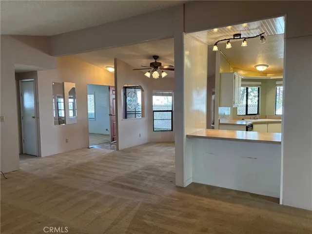 View from living space to dining area, kitchen passthrough and kitchen.