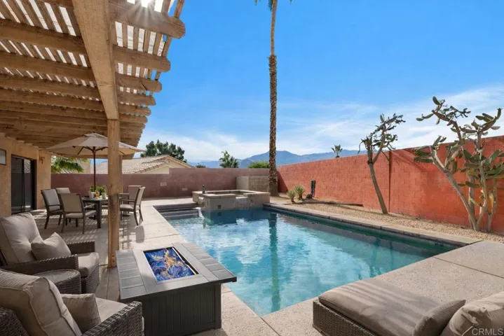 Gorgeous pool, spa, patio and large pool deck, with cozy firepit.