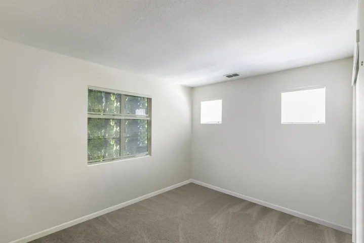 Spare room with light carpet and a textured ceiling