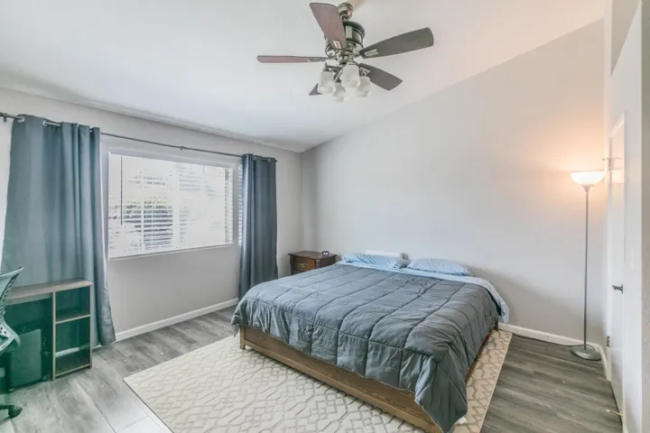 Bedroom featuring a ceiling fan and wood finished floors