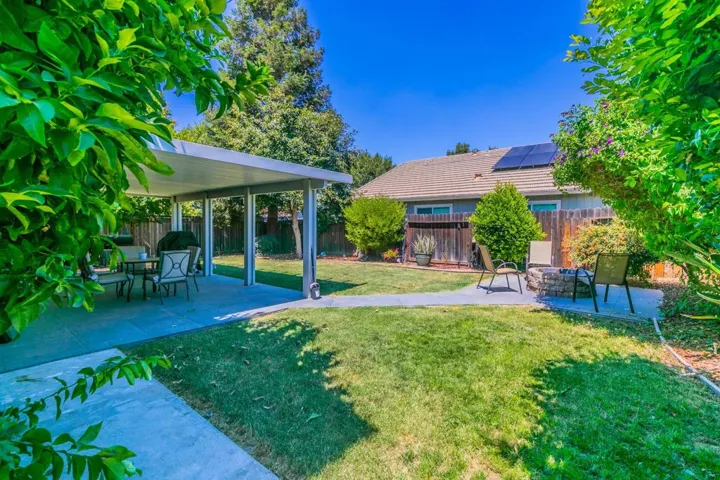 Fenced backyard with a patio
