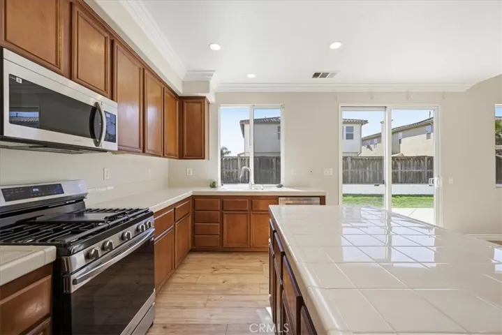 KITCHEN W/ ALL NEW STAINLESS APPLIANCES AND GRILL TOP STOVE