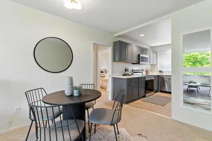 Dining area with light colored carpet, recessed lighting, and a textured ceiling