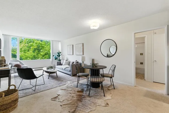 Living room with a textured ceiling and light colored carpet