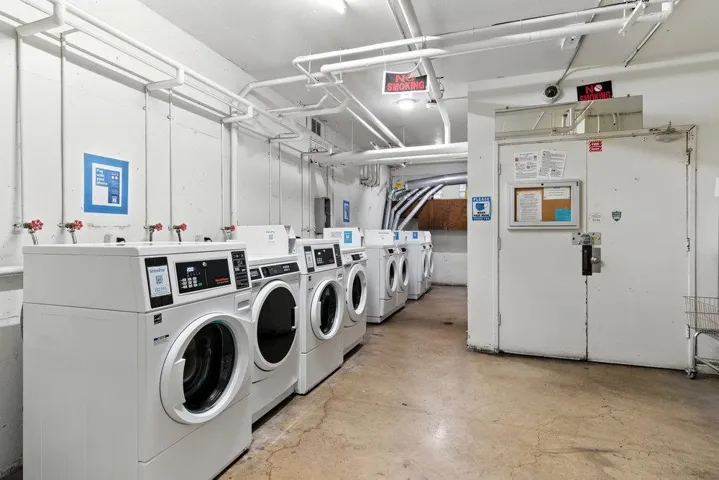 Shared laundry room featuring washing machine and dryer