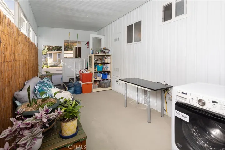 Storage area behind the carport with a door off the carport into the kitchen.