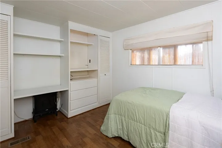 The second bedroom with a view of the closet space and shelving.