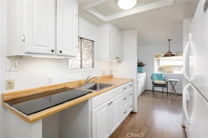 The kitchen opens into the dining/living room area with higher ceilings and lots of light.
