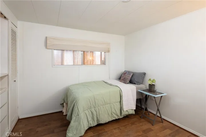 The second bedroom with built in shelving and closet.