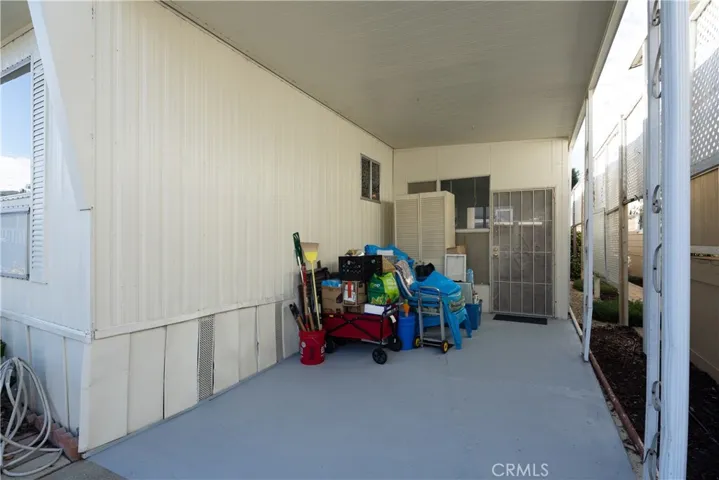 The large carport can easily hold two cars plus it opens into the side patio and door to the kitchen.