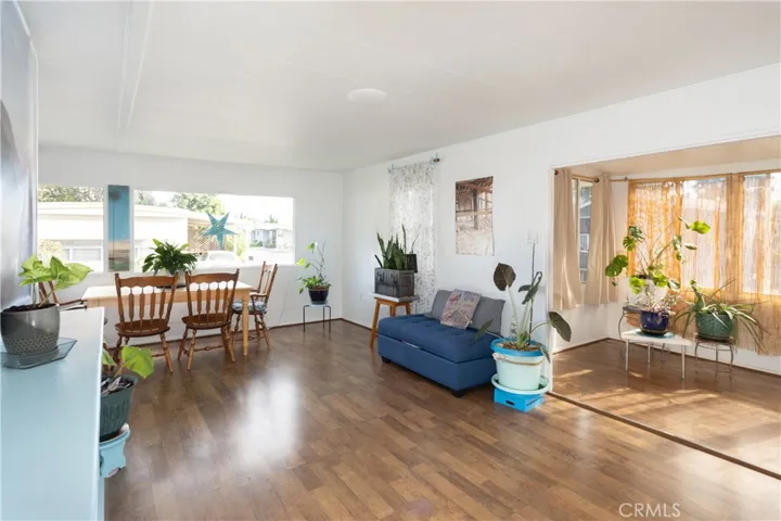 Large living area with a front patio with beautiful new flooring and fresh paint.