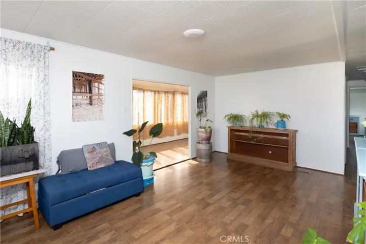 The living room with a peek into the front patio.