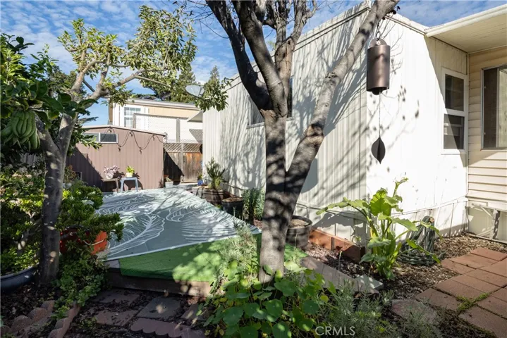 Large storage shed behind the carport on this well maintained mobile home.
