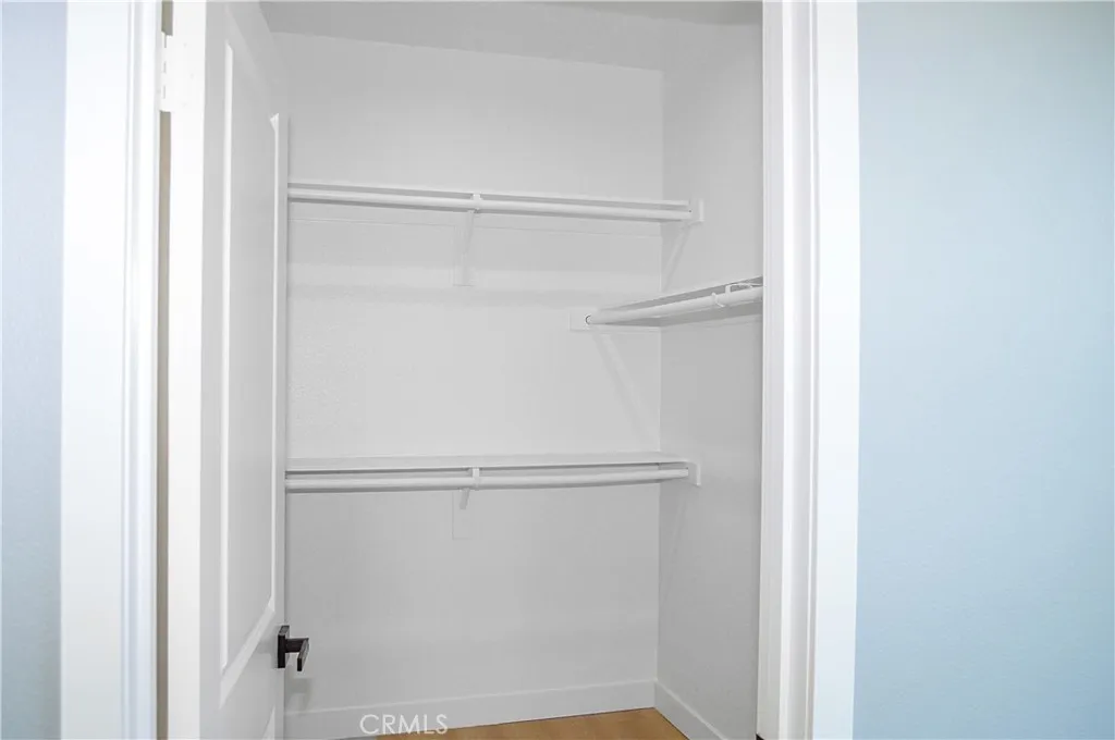 Primary bedroom walk-in closet