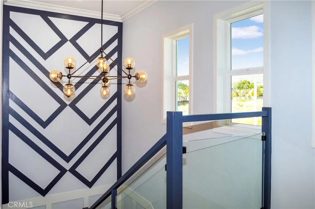 Custom wood work, fabulous lighting, glass panel inserts and multiple windows to enjoy the view make the transition between floors a delight