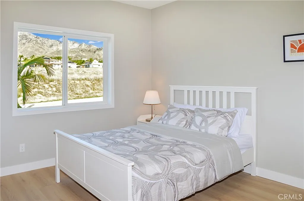 A quick stop at the main floor bedroom and bath before we head upstairs. The 4th bedroom in the main house offers gorgeous mountain views, fabulous flooring, recessed lighting, and is pre-wired for a ceiling fan and a TV (like all of the bedrooms).