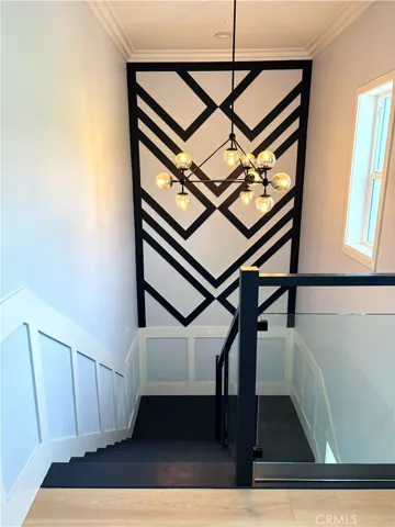Custom wood work, fabulous lighting, glass panel inserts and multiple windows to enjoy the view make the transition between floors a delight