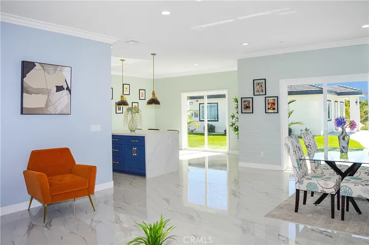 Beyond the kitchen island, there is a second space that can be used for dining instead, if desired.