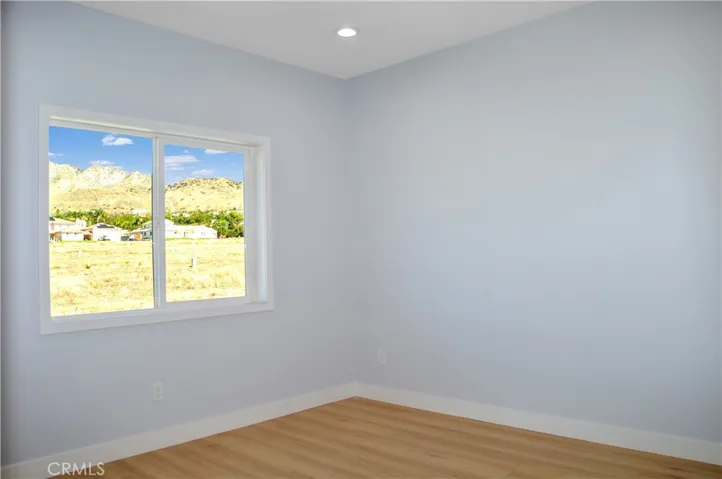 The 3rd bedroom upstairs offers more views, fabulous flooring, recessed lighting and is pre-wired for a ceiling fan and a TV