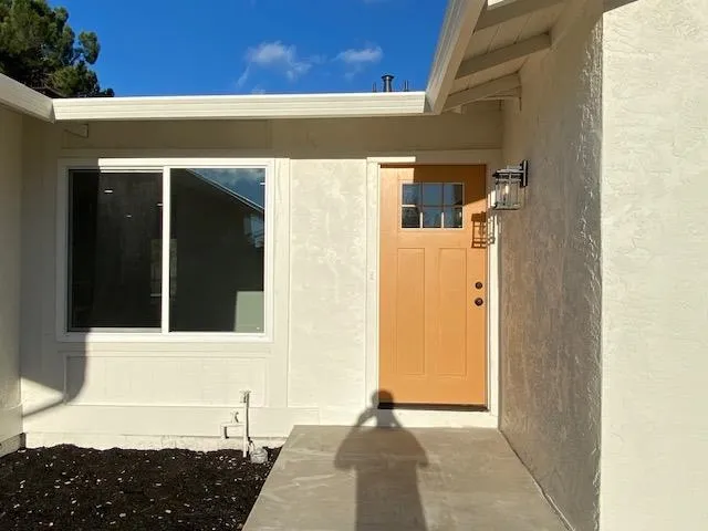 Entrance to property featuring stucco siding