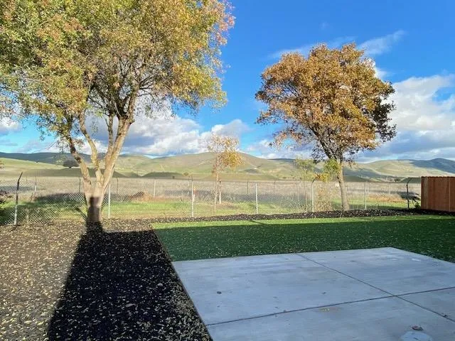 Fenced yard featuring a patio area and a mountain view