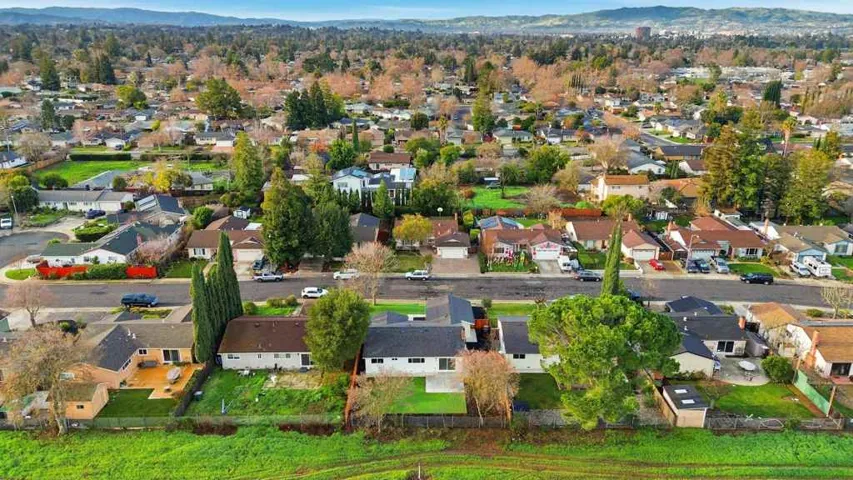 View of property location with mountains and nearby suburban area