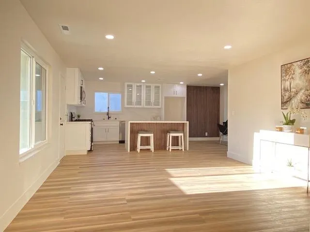 Unfurnished living room featuring light wood-type flooring and recessed lighting