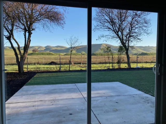 View of patio with a mountain view and a view of rural / pastoral area