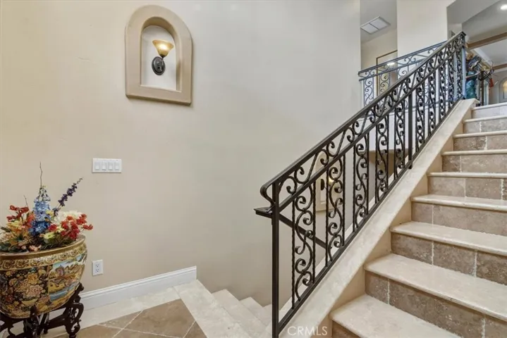 Travertine entry steps with iron railings