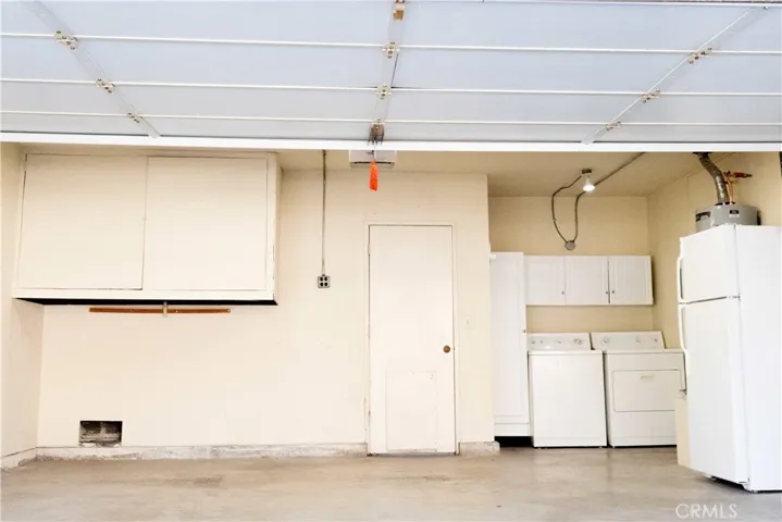 spacious garage with built in shelving, existing washer/dryer. direct entry to dining room and backyard.