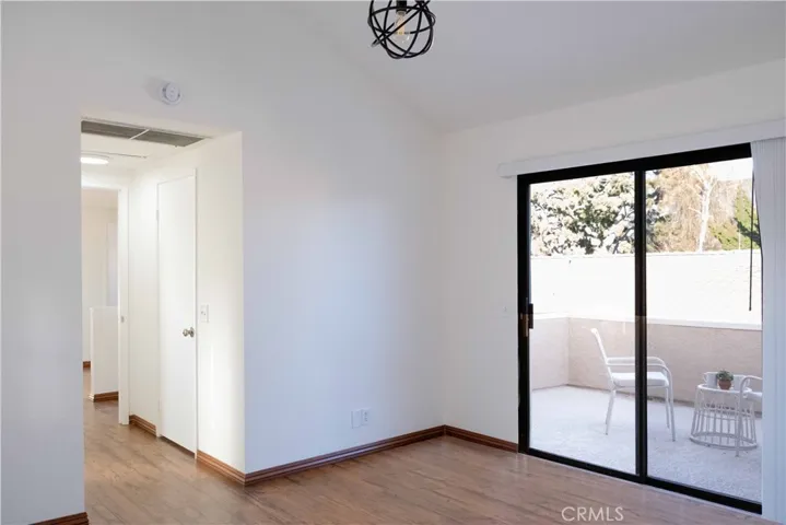 master bedroom suite with walk in closet and balcony with foothill views