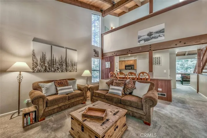 Open living room with beamed high ceilings
